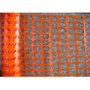 Orange warning barrier fence with oval mesh opening.lastic mesh 38 × 38mm