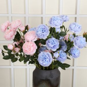The hotel living room is decorated with flower arrangements featuring artificial