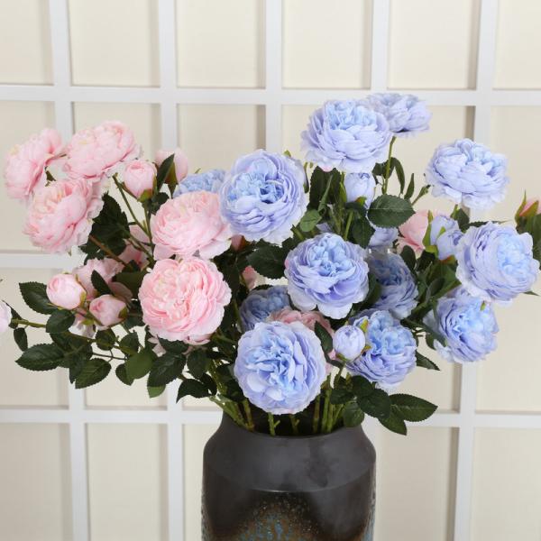 The hotel living room is decorated with flower arrangements featuring artificial