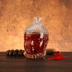 Cheap Unique Buddha Head Shaped Glass Bottles with Aluminum Plastic PP Collar Material for sale