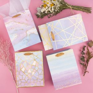 Designer Folding Glossy Shopping Paper Bag With Ribbon Handle and Gravure