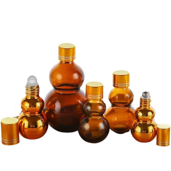 Quality Customizable Premium 10ml/50ml/100ml Amber Glass Perfume Oil Roll On Bottles With Golden Mirror Finish‌ Dual Golden Caps & Thickened Base‌ wholesale
