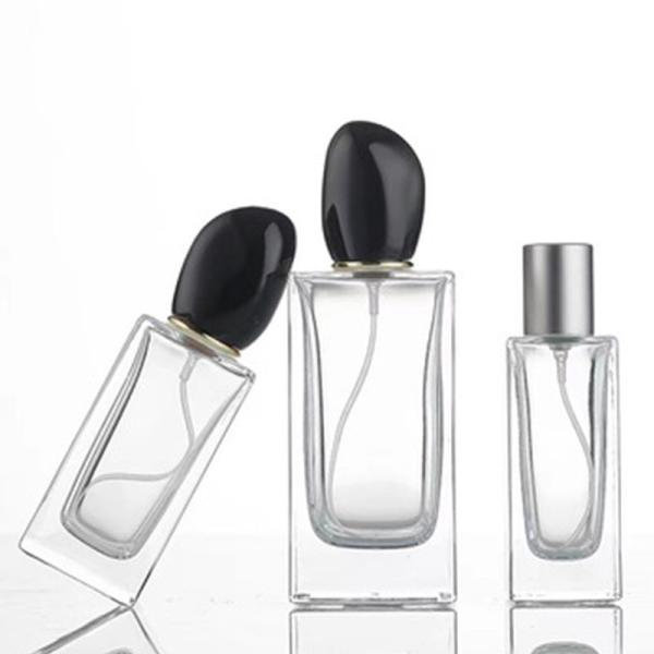 Quality Square Glass Perfume Bottle with 50ml 100ml Capacity and Distinctive Irregular-shaped Cap wholesale