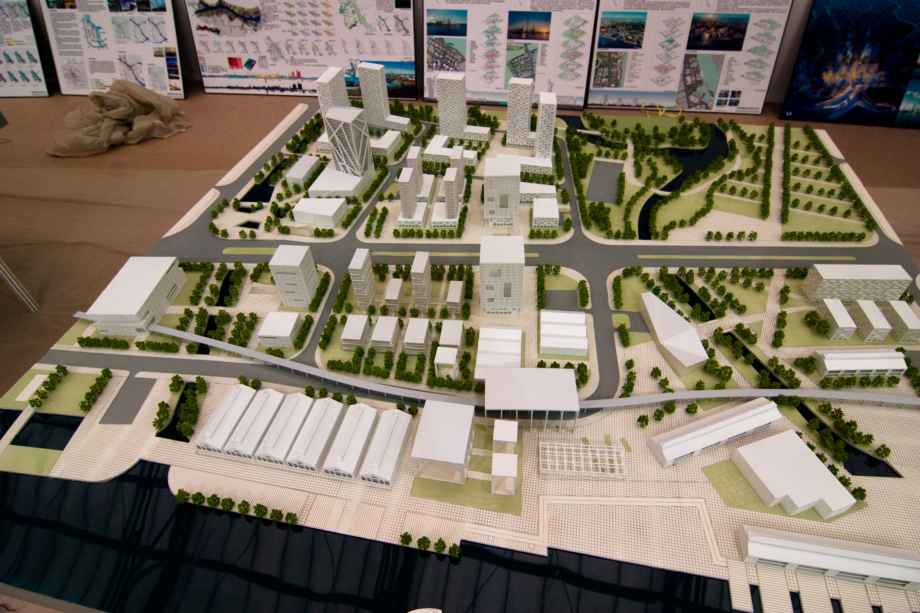 Architectural model urban block layout with mixed-use buildings, detailed green spaces and traffic planning