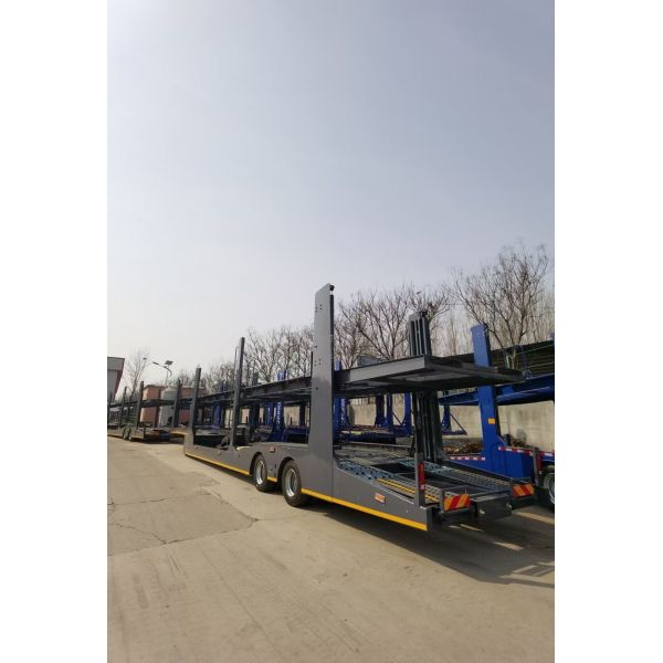 Quality Fully Enclosed Russia Hydraulic Lifting 2/3 Axle Car Transport Trailer with Triangle Tire wholesale